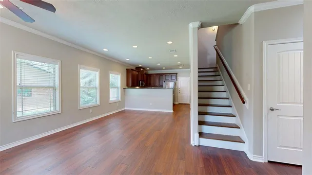 a view of wooden floor and windows in a room