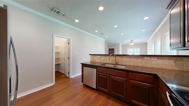 a kitchen with stainless steel appliances granite countertop a refrigerator stove and sink