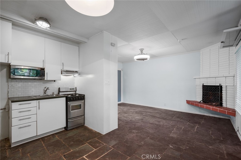 2025 Cloverfield Boulevard, Unit C Santa Monica, CA 90404 - Photo 11 of 36 a kitchen with granite countertop a sink cabinets and stainless steel appliances