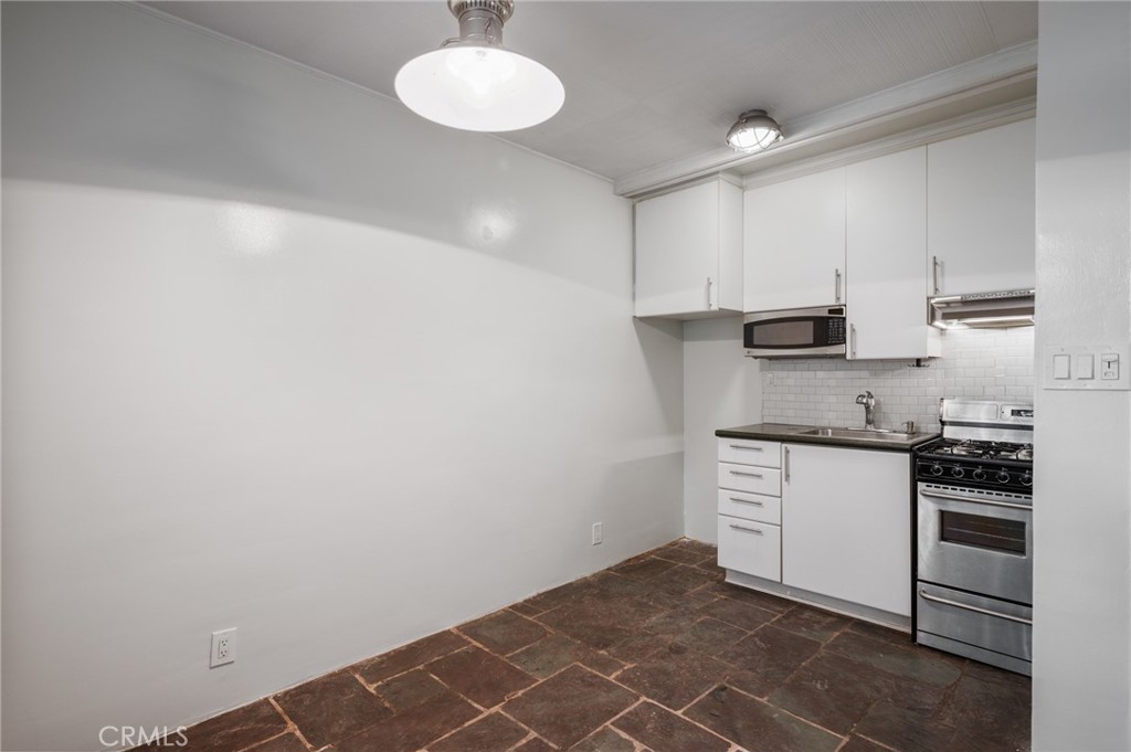 2025 Cloverfield Boulevard, Unit C Santa Monica, CA 90404 - Photo 15 of 36 a kitchen with stainless steel appliances a stove and white cabinets