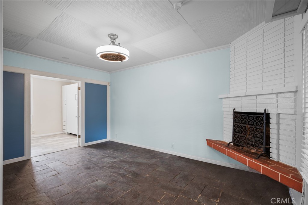 2025 Cloverfield Boulevard, Unit C Santa Monica, CA 90404 - Photo 16 of 36 an empty room with fireplace and windows