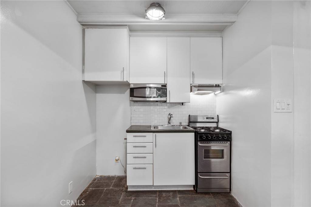 2025 Cloverfield Boulevard, Unit C Santa Monica, CA 90404 - Photo 19 of 36 a kitchen with stainless steel appliances granite countertop a sink and cabinets