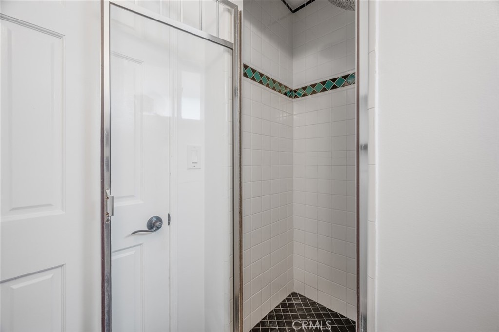 2025 Cloverfield Boulevard, Unit C Santa Monica, CA 90404 - Photo 23 of 36 a bathroom with a glass shower door