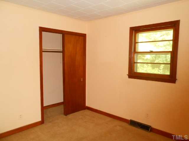 321 Gravitte Road Roxboro, NC 27573 - Photo 8 of 9 an empty room with a window and closet
