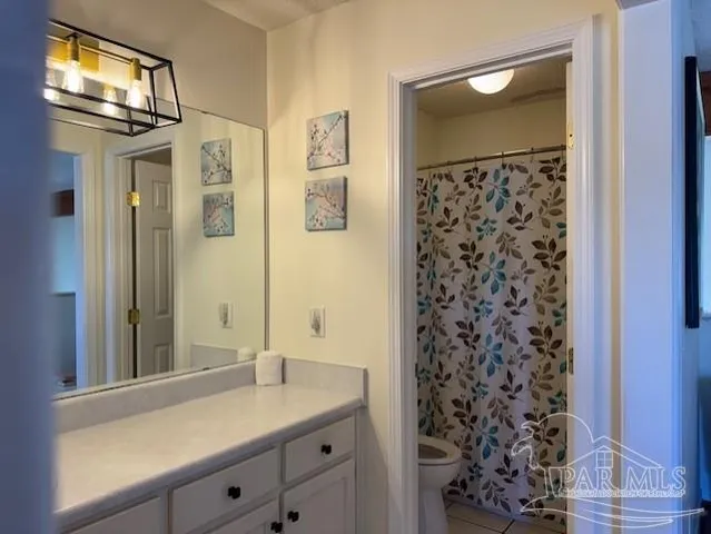 a bathroom with a granite countertop sink a mirror and shower
