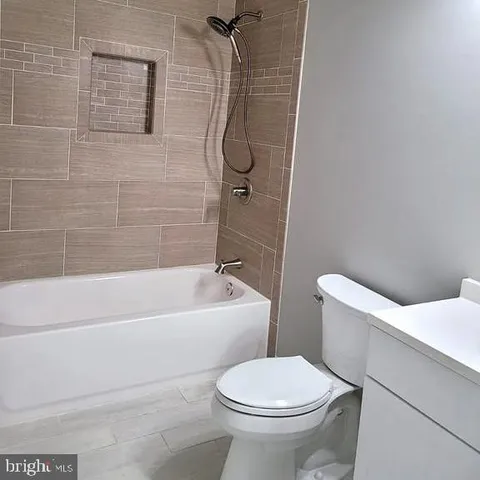 a bathroom with a toilet and a bath tub
