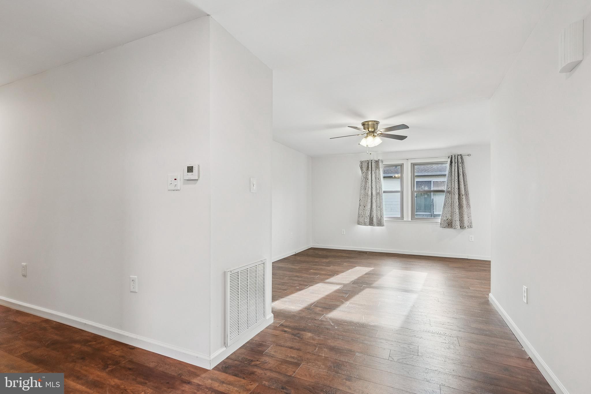 715 Cooper Landing Road Cherry Hill, NJ 08002 - Photo 11 of 23 a view of a livingroom with wooden floor and a ceiling fan