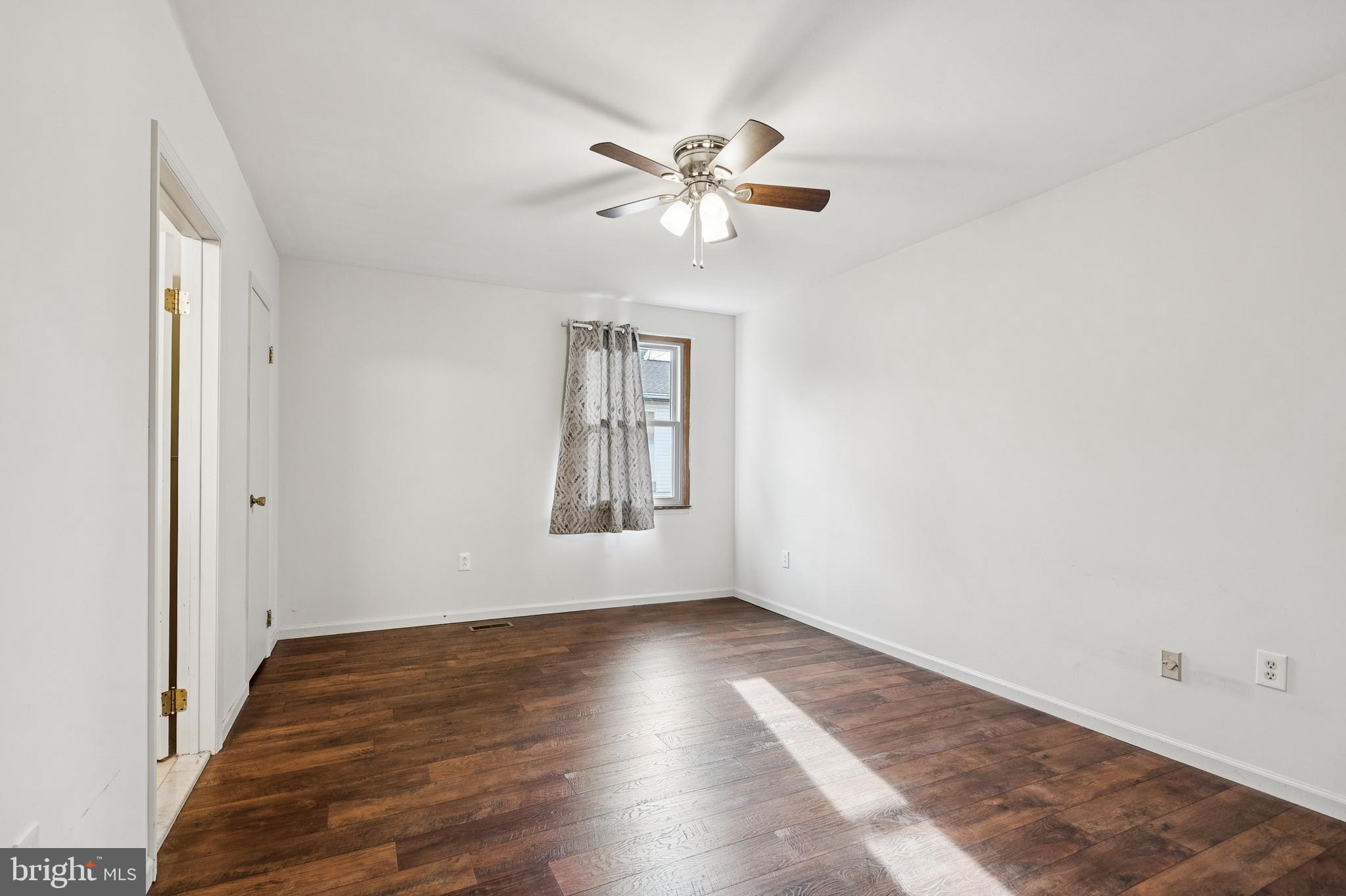 715 Cooper Landing Road Cherry Hill, NJ 08002 - Photo 16 of 23 a view of an empty room with wooden floor and a window
