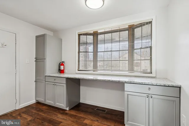 a kitchen with granite countertop white cabinets and white appliances