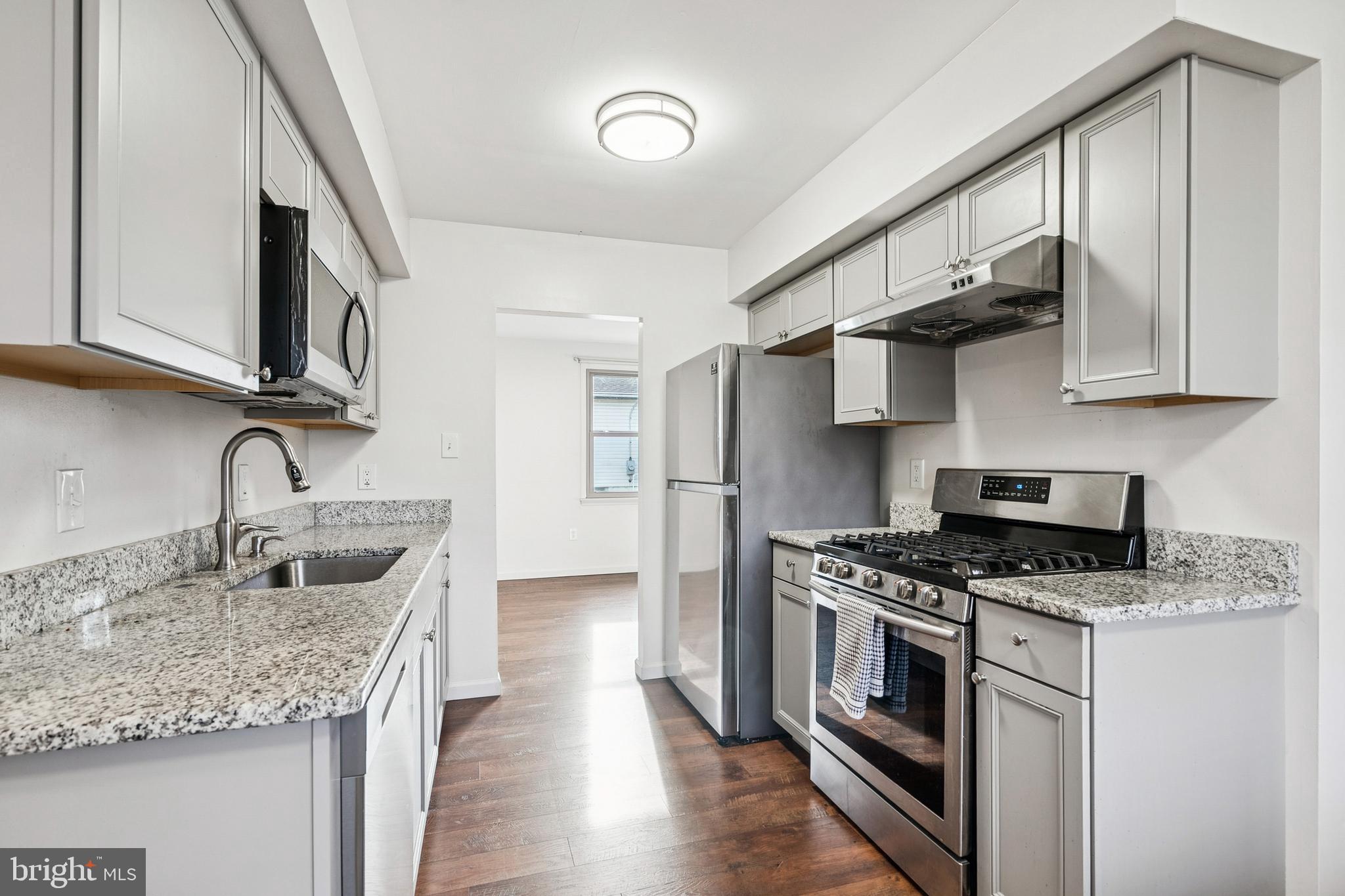 715 Cooper Landing Road Cherry Hill, NJ 08002 - Photo 6 of 23 a kitchen with stainless steel appliances granite countertop a sink stove and cabinets
