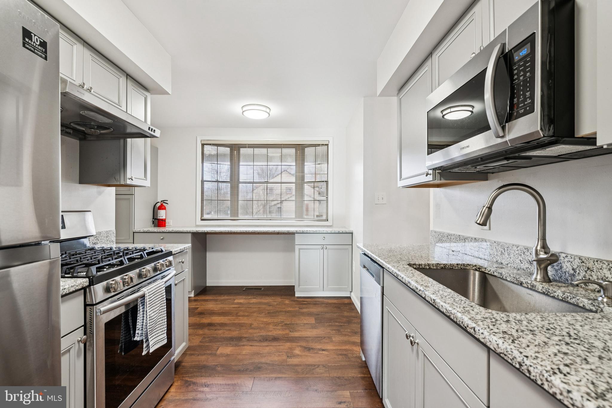 715 Cooper Landing Road Cherry Hill, NJ 08002 - Photo 7 of 23 a kitchen with stainless steel appliances granite countertop a sink stove top oven and cabinets