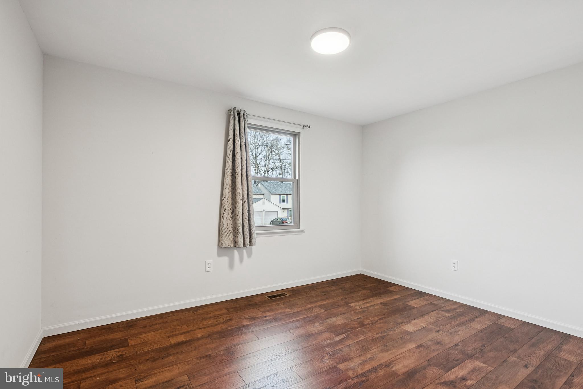 715 Cooper Landing Road Cherry Hill, NJ 08002 - Photo 8 of 23 an empty room with wooden floor and windows