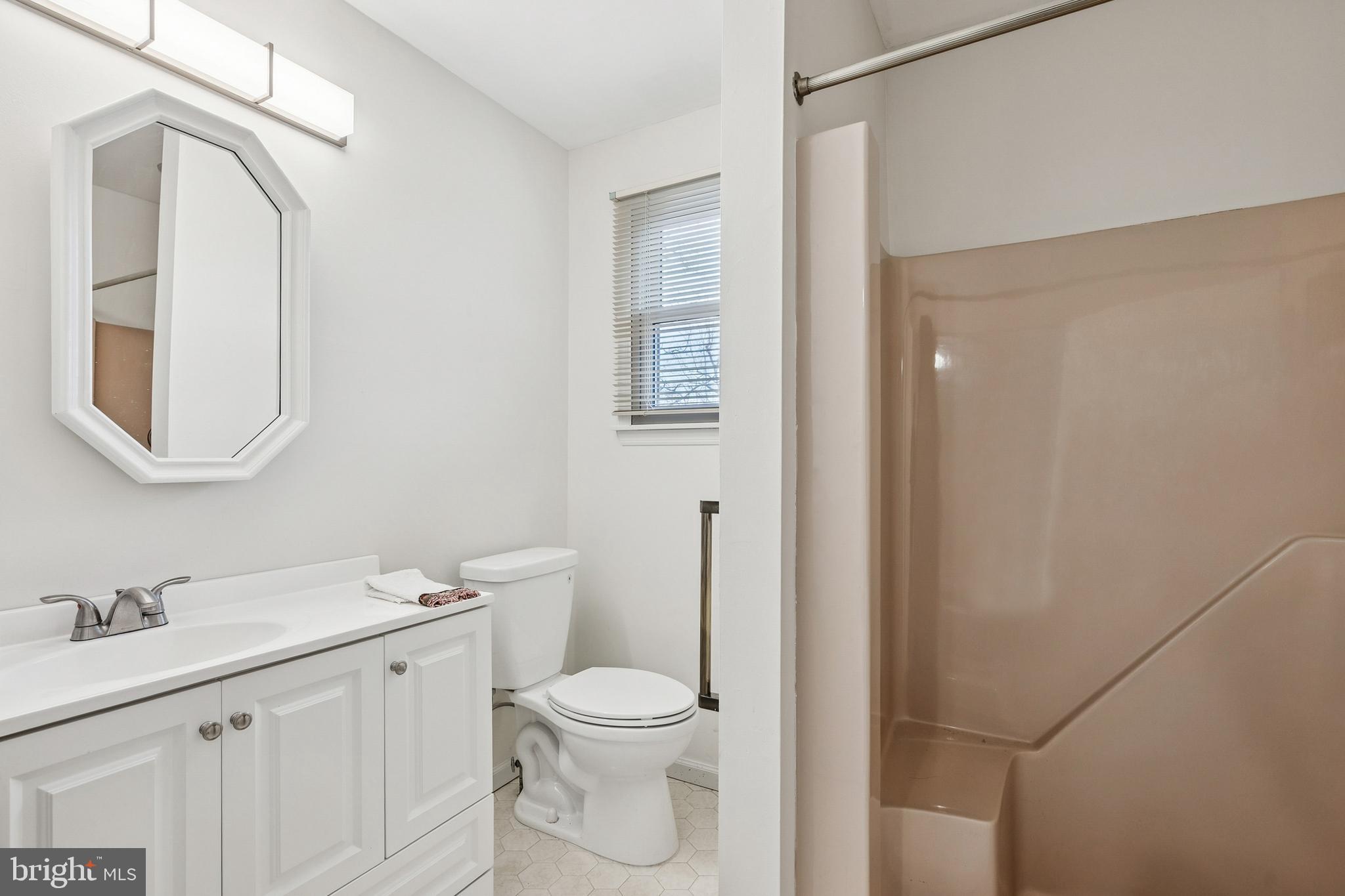 715 Cooper Landing Road Cherry Hill, NJ 08002 - Photo 9 of 23 a bathroom with a toilet a sink a vanity and mirror