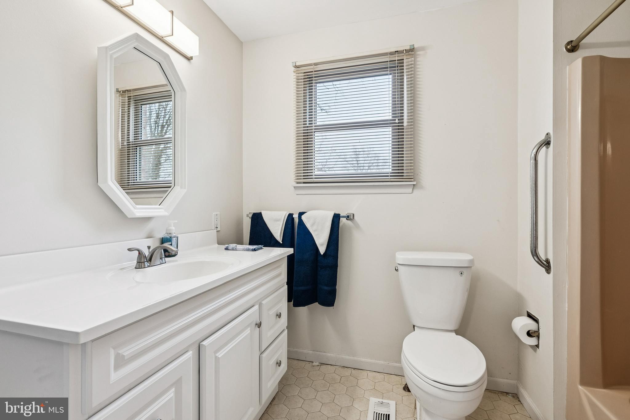 715 Cooper Landing Road Cherry Hill, NJ 08002 - Photo 10 of 23 a bathroom with a toilet sink vanity and mirror