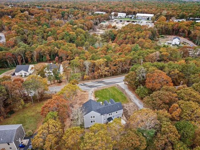 an aerial view of residential houses with outdoor space