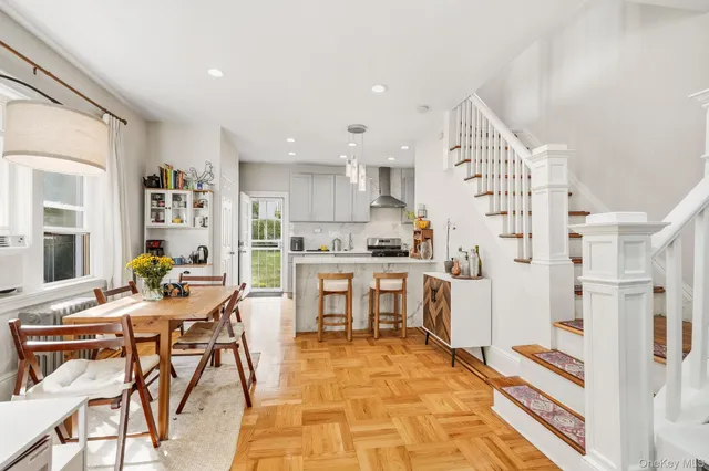 a kitchen with a refrigerator and white cabinets
