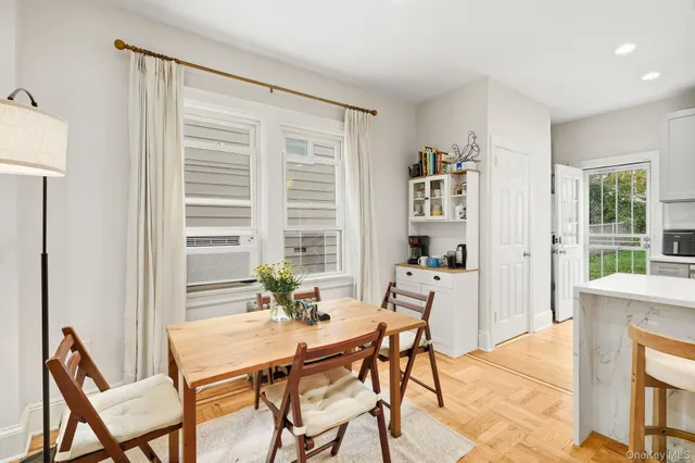 a dining room with furniture and window