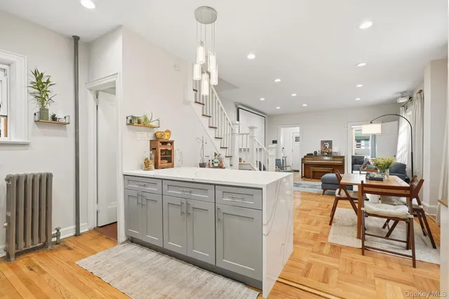 a kitchen with stainless steel appliances kitchen island granite countertop a sink and a refrigerator