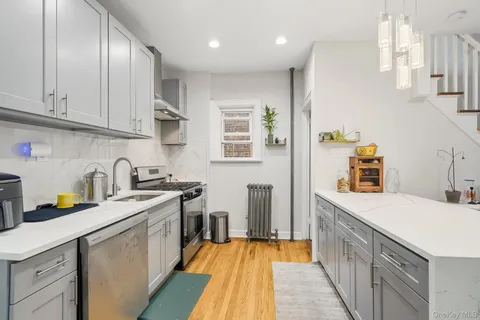 a kitchen with a sink a stove and cabinets