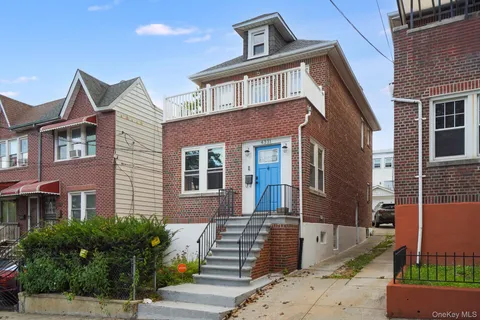 a front view of a residential apartment building with a yard