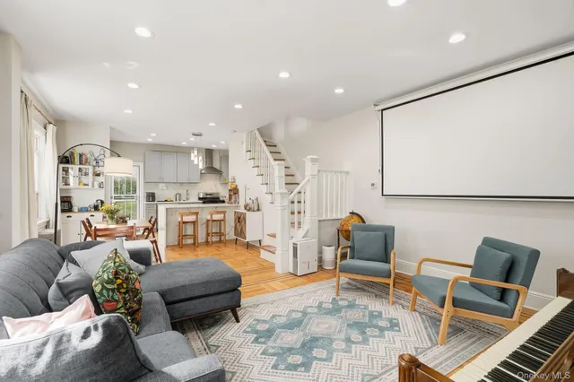 a living room with furniture and kitchen view