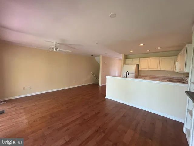 a kitchen with a refrigerator and a stove top oven