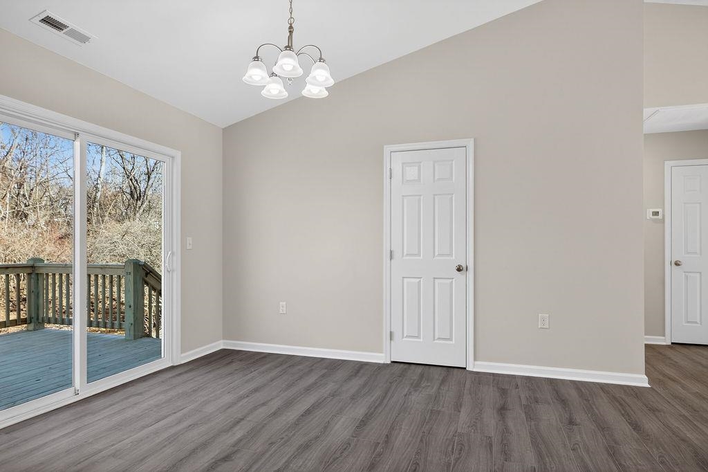 1637 A Street Waynesboro, VA 22980 - Photo 11 of 42 a view of an empty room with wooden floor and a window