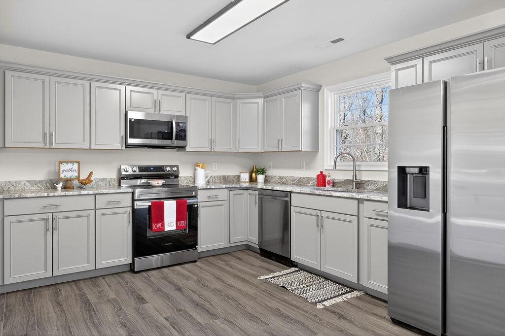 1637 A Street Waynesboro, VA 22980 - Photo 14 of 42 a kitchen with granite countertop a refrigerator stove and sink