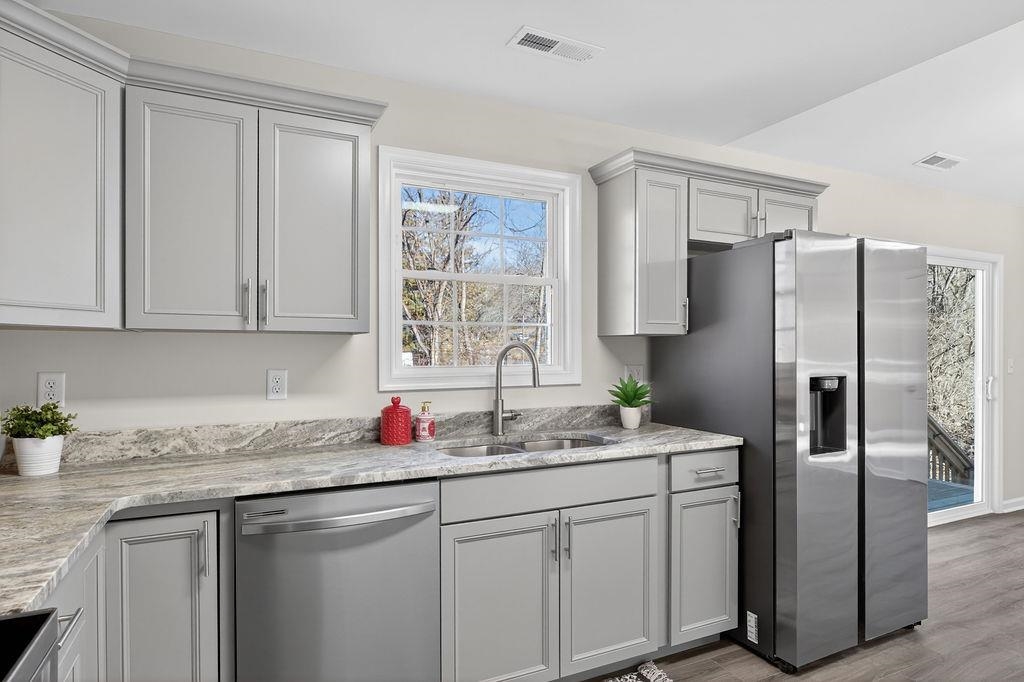1637 A Street Waynesboro, VA 22980 - Photo 17 of 42 a kitchen with stainless steel appliances granite countertop a sink refrigerator and cabinets