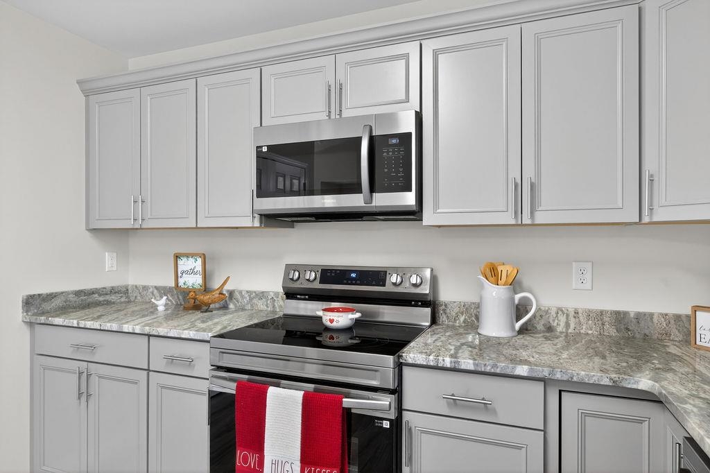 1637 A Street Waynesboro, VA 22980 - Photo 18 of 42 a kitchen with granite countertop white cabinets and a stove top oven