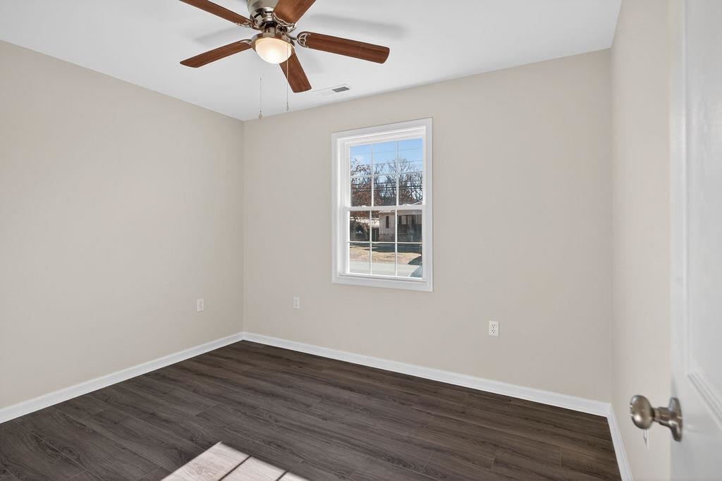 1637 A Street Waynesboro, VA 22980 - Photo 20 of 42 a view of an empty room with wooden floor and a ceiling fan
