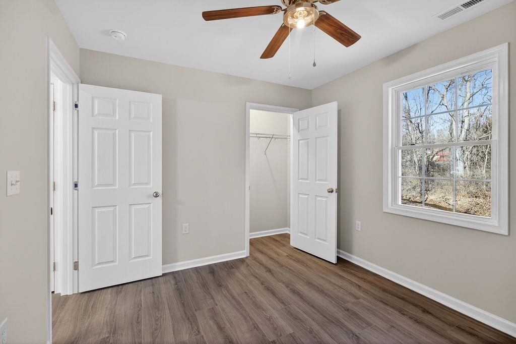 1637 A Street Waynesboro, VA 22980 - Photo 24 of 42 an empty room with wooden floor chandelier fan and windows