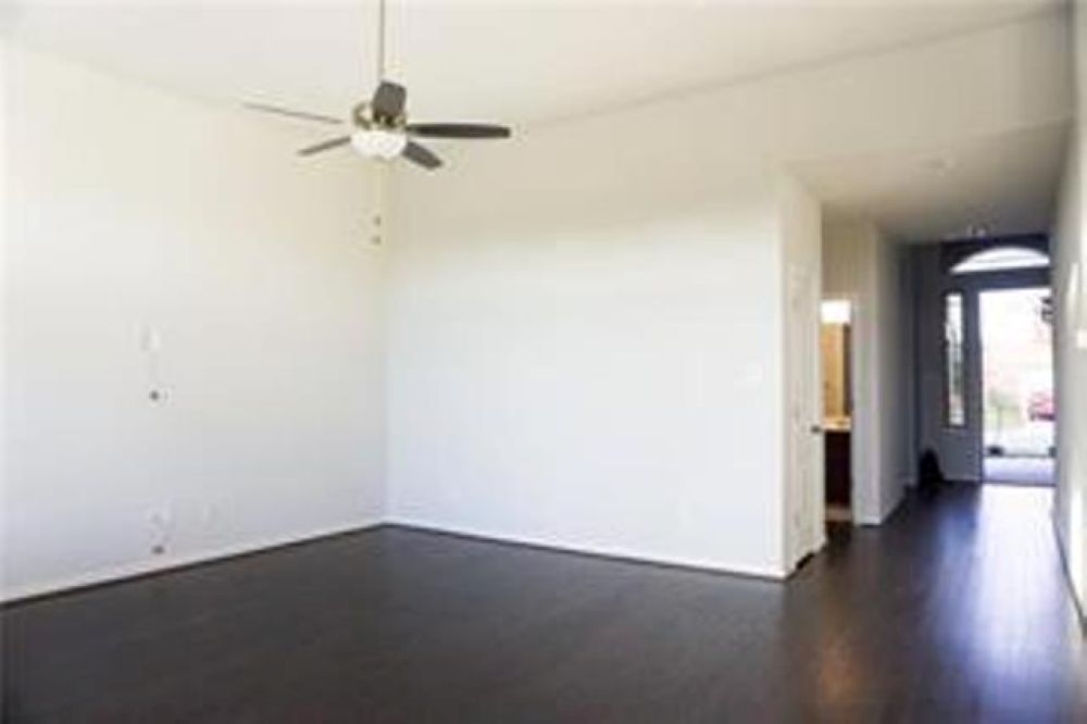 4021 Gildas Path Pflugerville, TX 78660 - Photo 16 of 19 Spacious room featuring wood-finish flooring, a ceiling fan with integrated lighting, and neutral wall tones