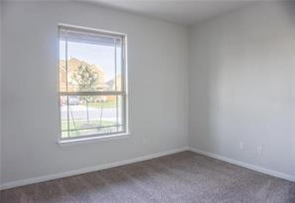 4021 Gildas Path Pflugerville, TX 78660 - Photo 3 of 19 Neutral wall paint with baseboard trim and carpet flooring