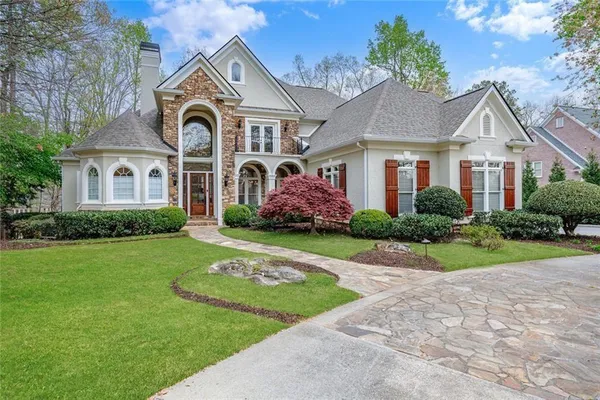 a front view of a house with garden