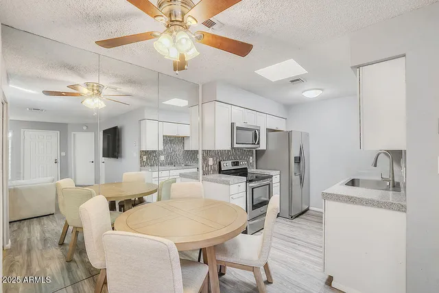 a large kitchen with a table and chairs