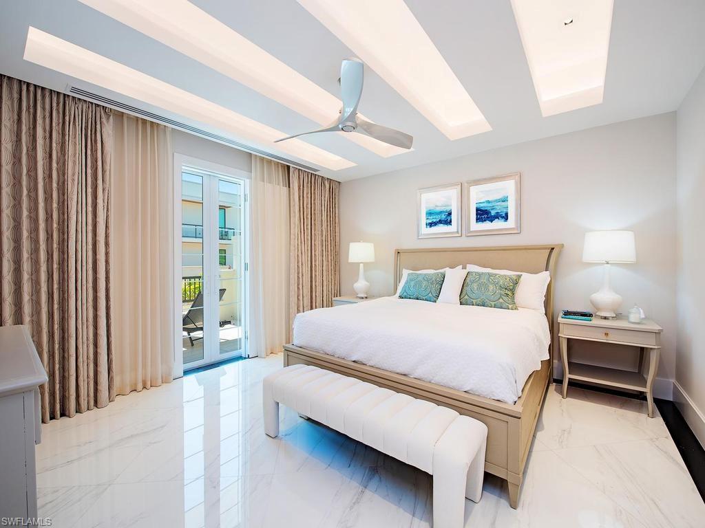 490 5th Street South, Unit 101 Naples, FL 34102 - Photo 12 of 34 a bed room with a bed and a window