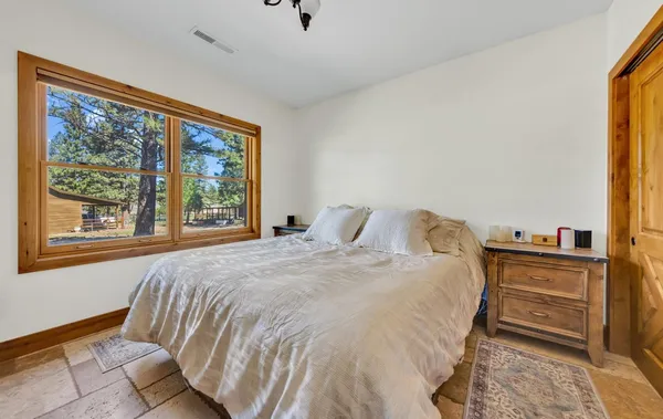 a bedroom with a bed and a large window