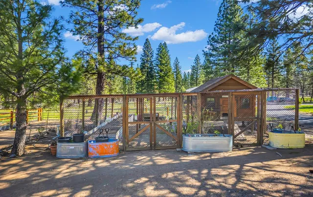 a view of a house with backyard outdoor seating and wooden fence