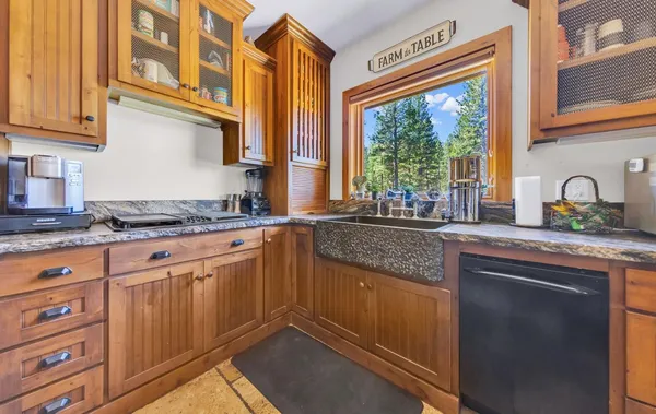 a kitchen with granite countertop a sink and a window