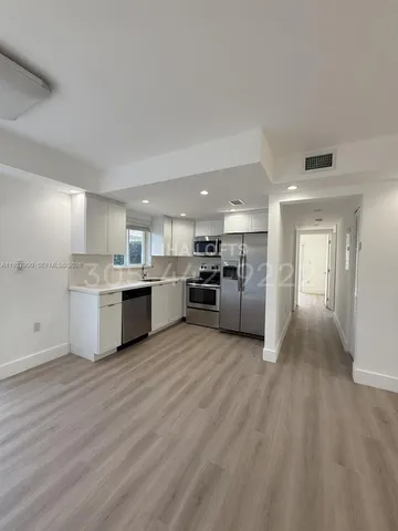 a view of a kitchen with a sink wooden floor and kitchen