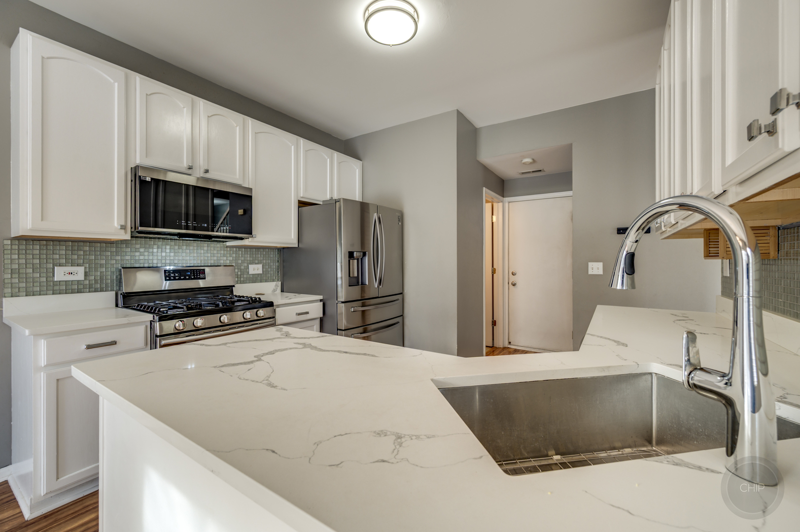4055 Blackstone Drive, Unit 4055 Aurora, IL 60504 - Photo 12 of 43 a kitchen with stainless steel appliances a stove a sink a refrigerator white cabinets and a refrigerator