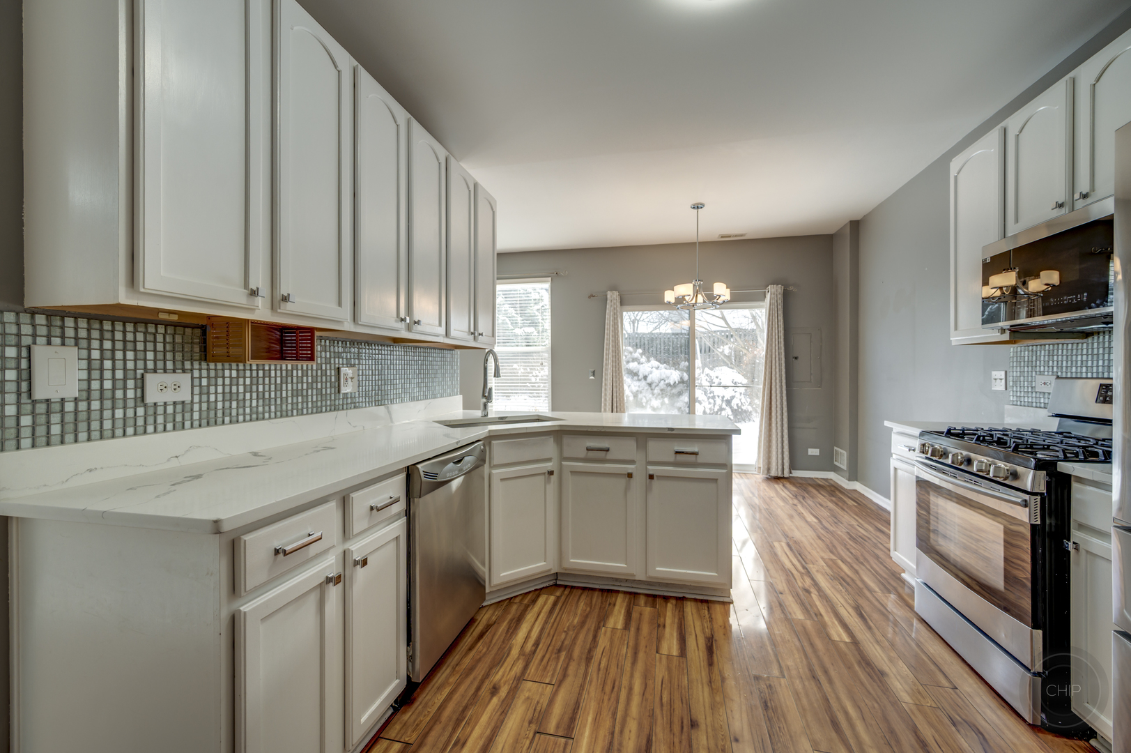 4055 Blackstone Drive, Unit 4055 Aurora, IL 60504 - Photo 15 of 43 a kitchen with a sink stove and cabinets