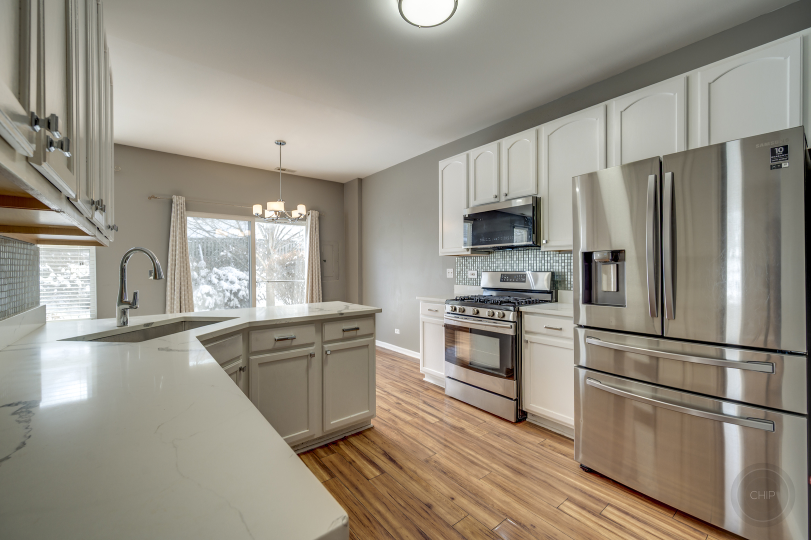 4055 Blackstone Drive, Unit 4055 Aurora, IL 60504 - Photo 16 of 43 a kitchen with granite countertop a refrigerator stove and oven