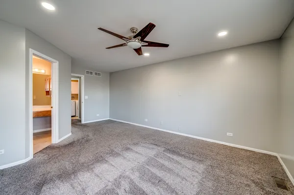 an empty room with closet and a window