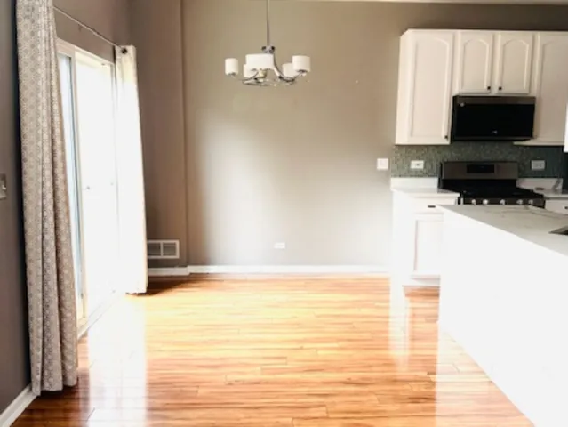 a view of a kitchen with microwave and cabinets