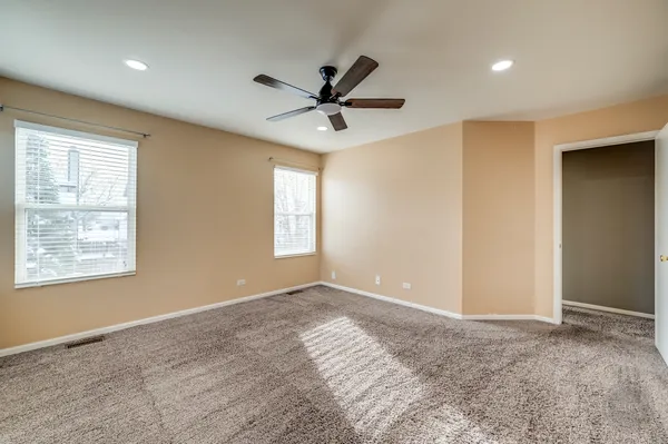 a view of a livingroom with a window and a ceiling fan