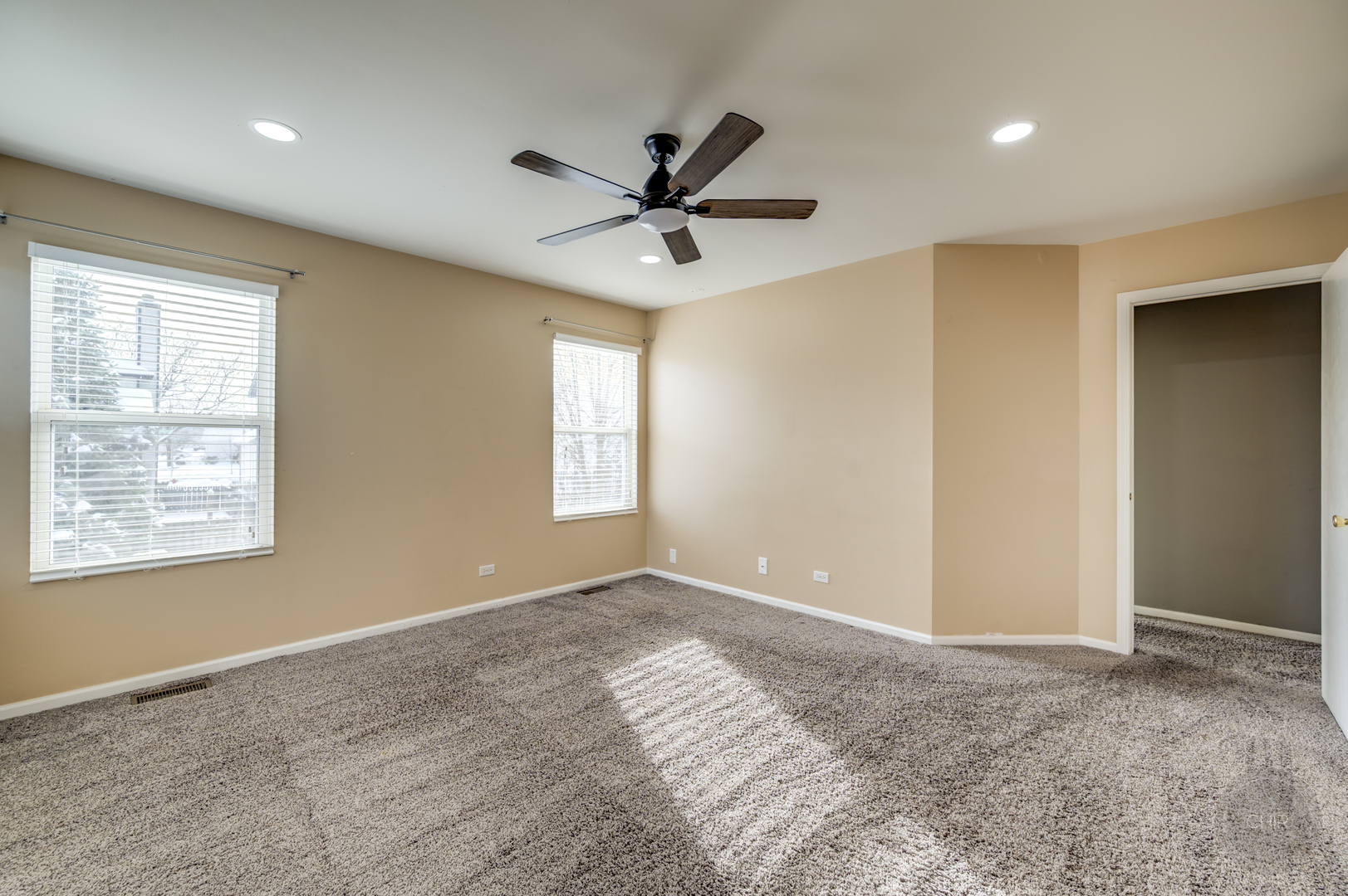 4055 Blackstone Drive, Unit 4055 Aurora, IL 60504 - Photo 35 of 43 a view of a livingroom with a window and a ceiling fan