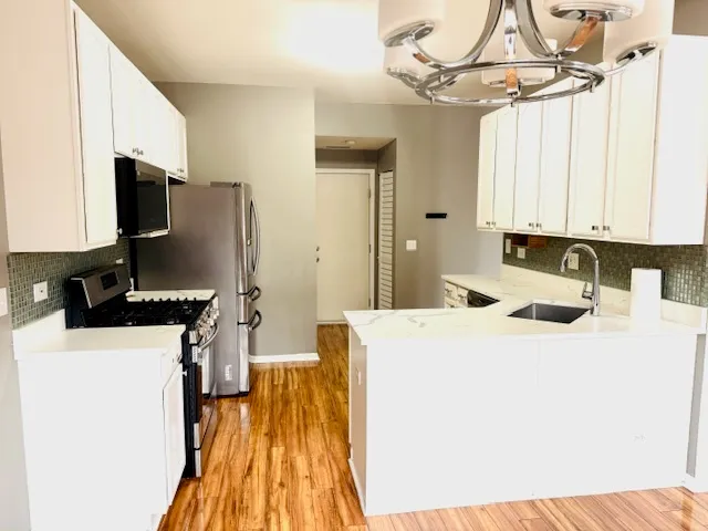 a kitchen with a sink a stove and a refrigerator
