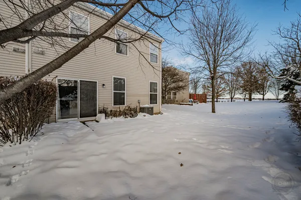 a view of a house with snow on the road